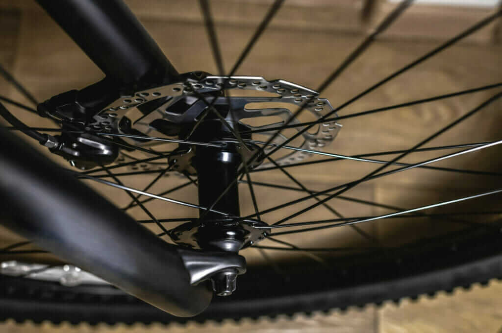 A close up of a mountain bike's front wheel.