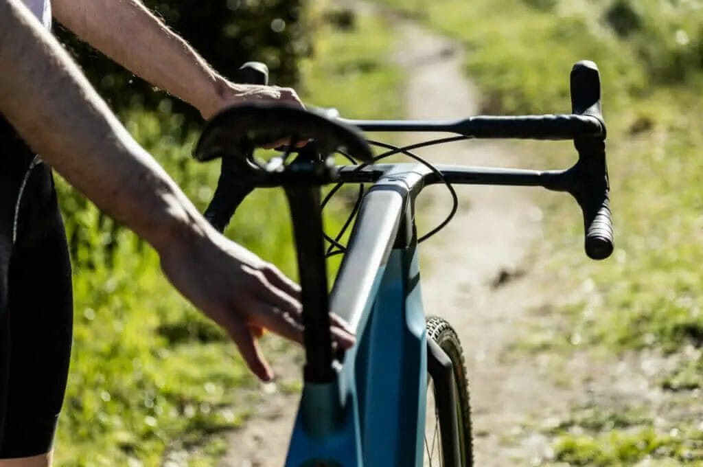 A person riding a bike on a dirt path.