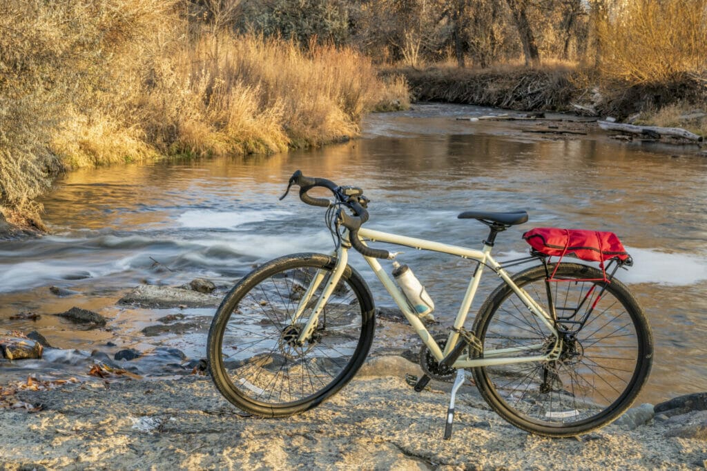 A bike leaning against a river.
