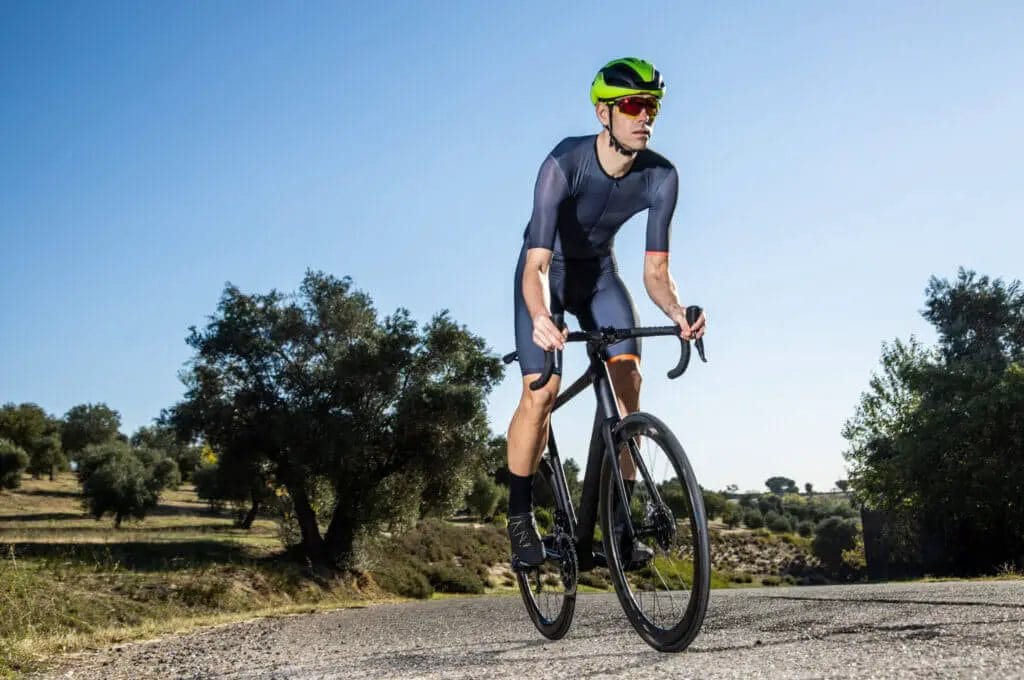 A man riding a bike on a country road.