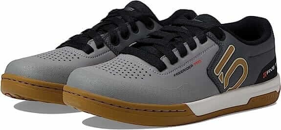 A pair of grey and brown shoes with white soles.