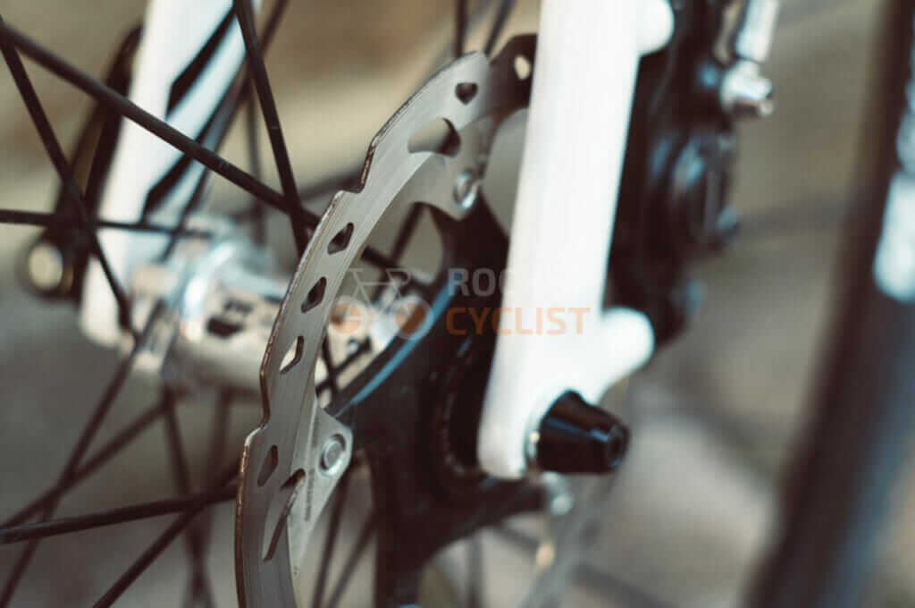 A close up of a bicycle's disc brake.