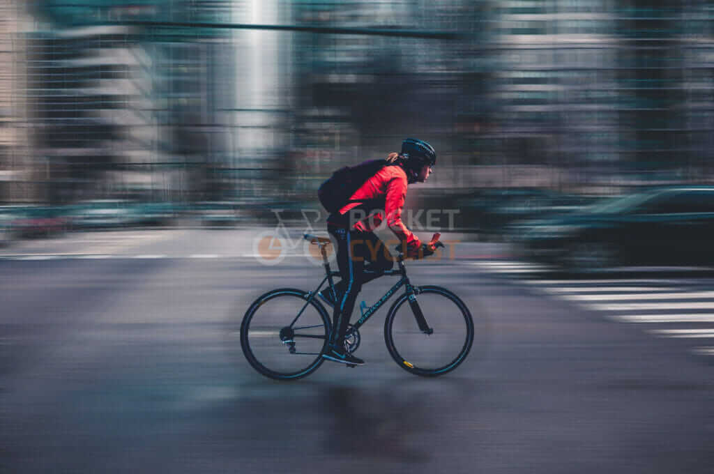 A man riding a bike on a city street.