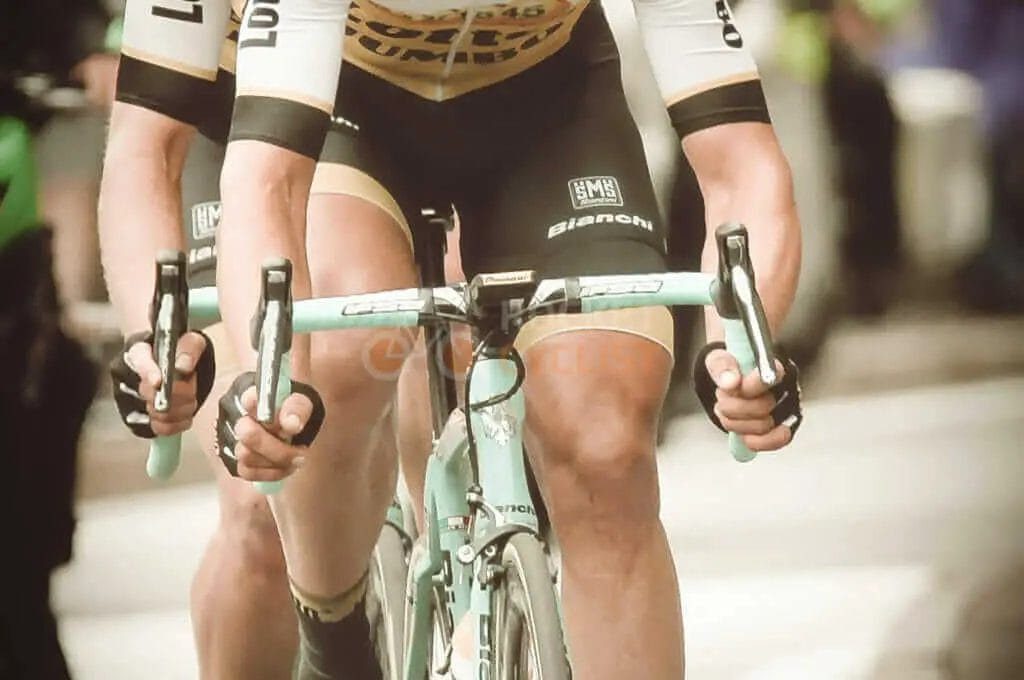 Two cyclists are racing on a street.