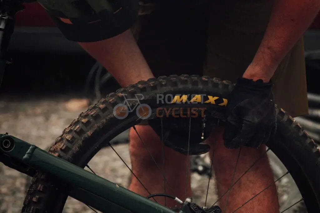 A man is putting a tire on a bike.