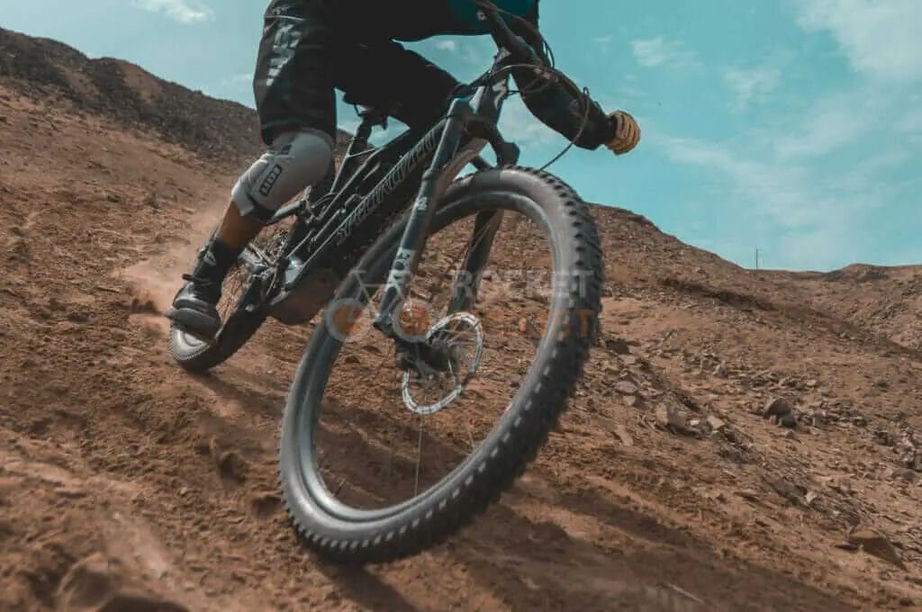 A man riding a mountain bike in the desert.