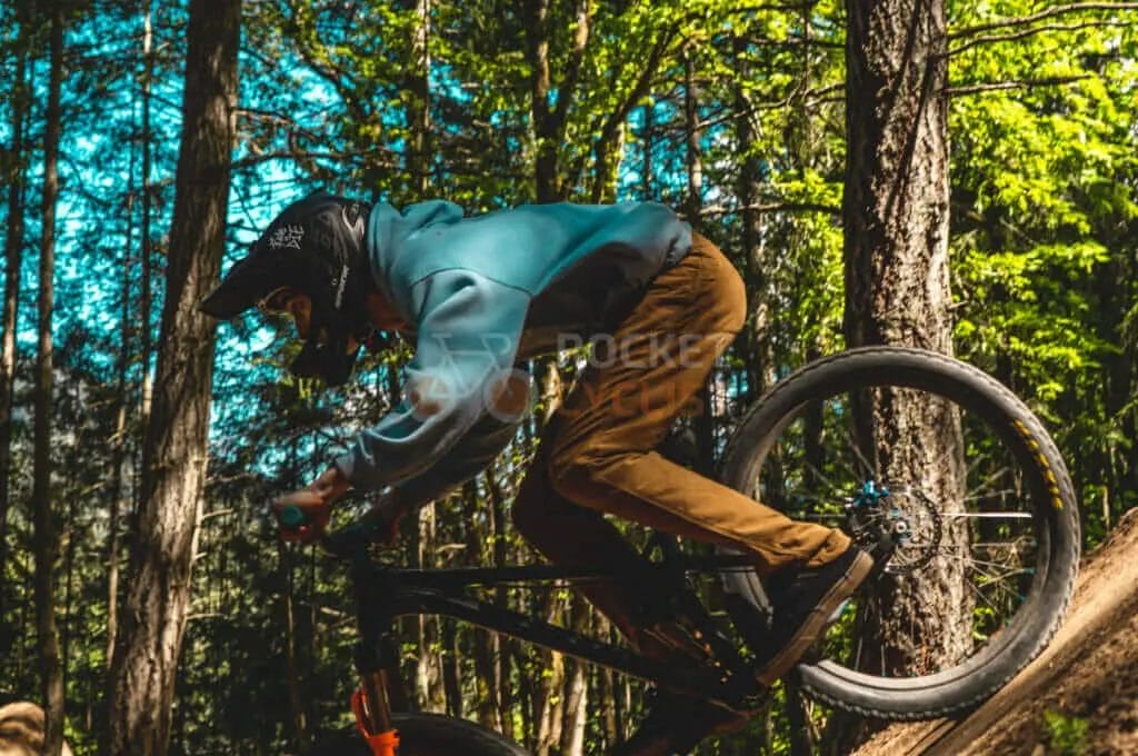 A man riding a mountain bike in the woods.