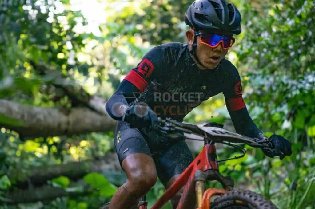 A man riding a mountain bike in the woods.