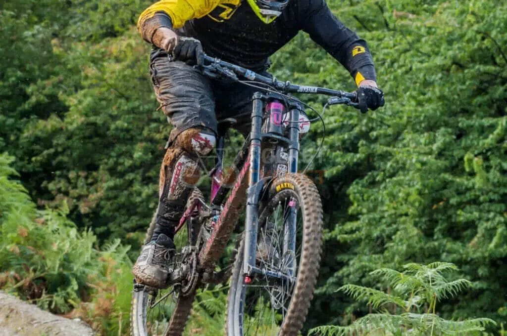 A man riding a mountain bike in the woods.