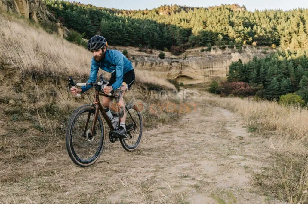 A man riding a mountain bike on a dirt trail.