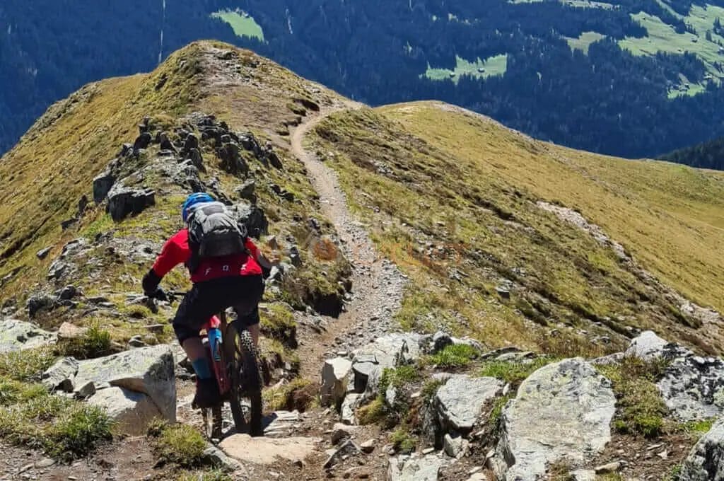 A person riding a mountain bike on a rocky trail.