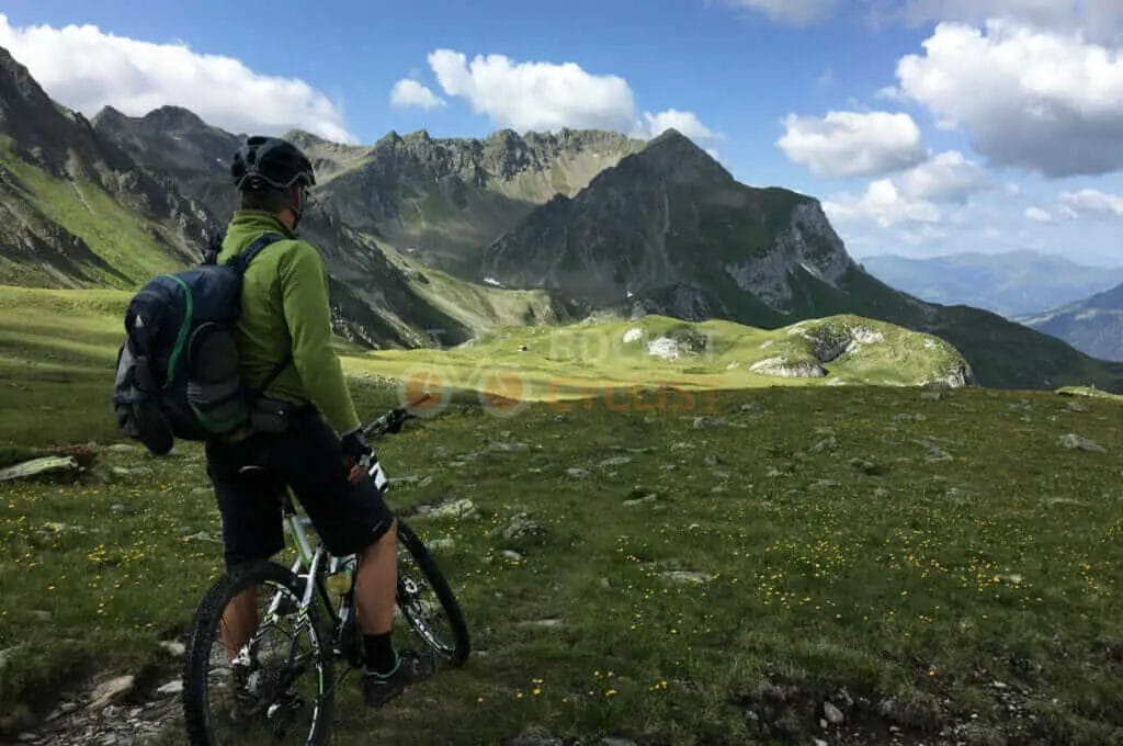 A man riding a mountain bike in the mountains.