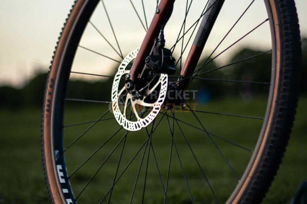 A mountain bike is parked on a grassy field.