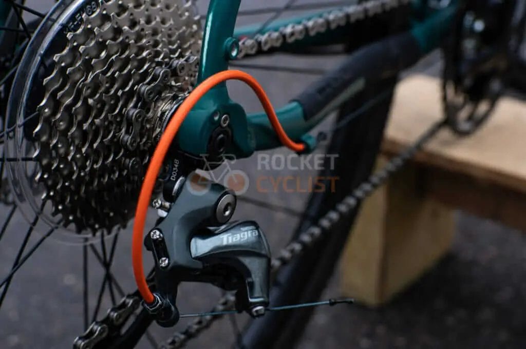 A close up of a bicycle with a chain and gears.