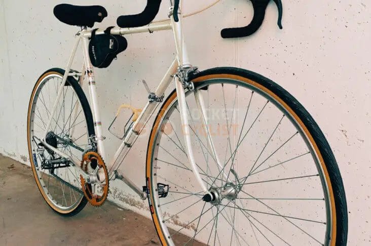 A bicycle leaning against a wall.