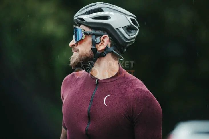 A man wearing a cycling jersey and sunglasses.