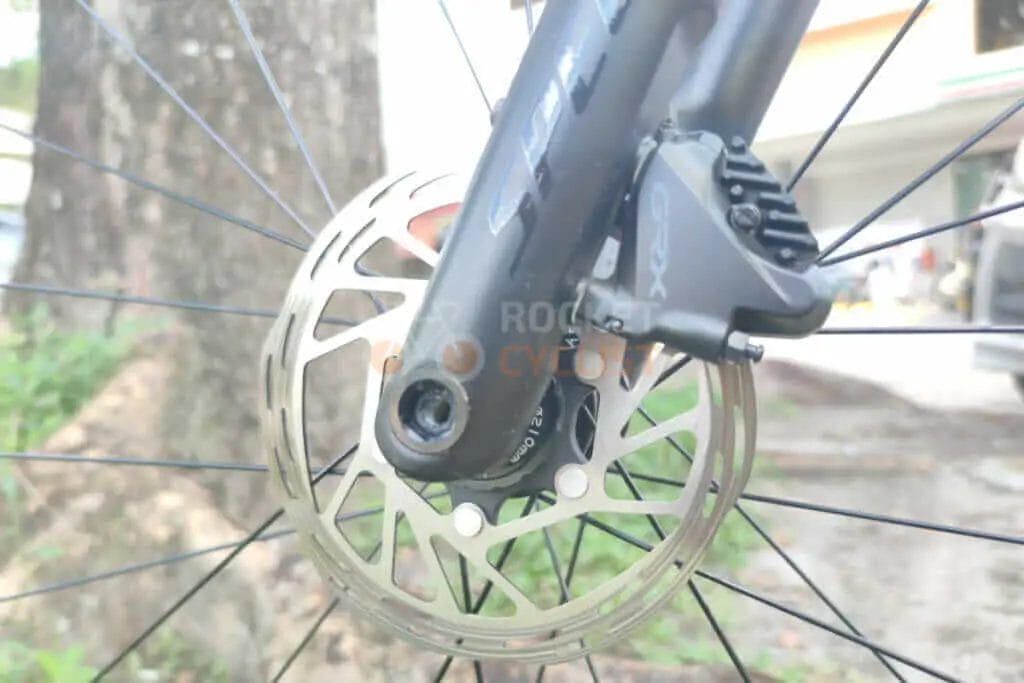A close up of a bicycle wheel with a disc on it.