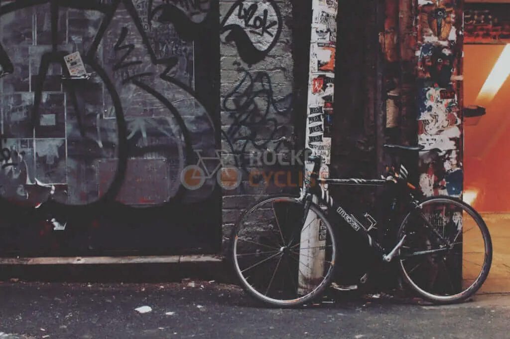 A bike leaning against a wall.