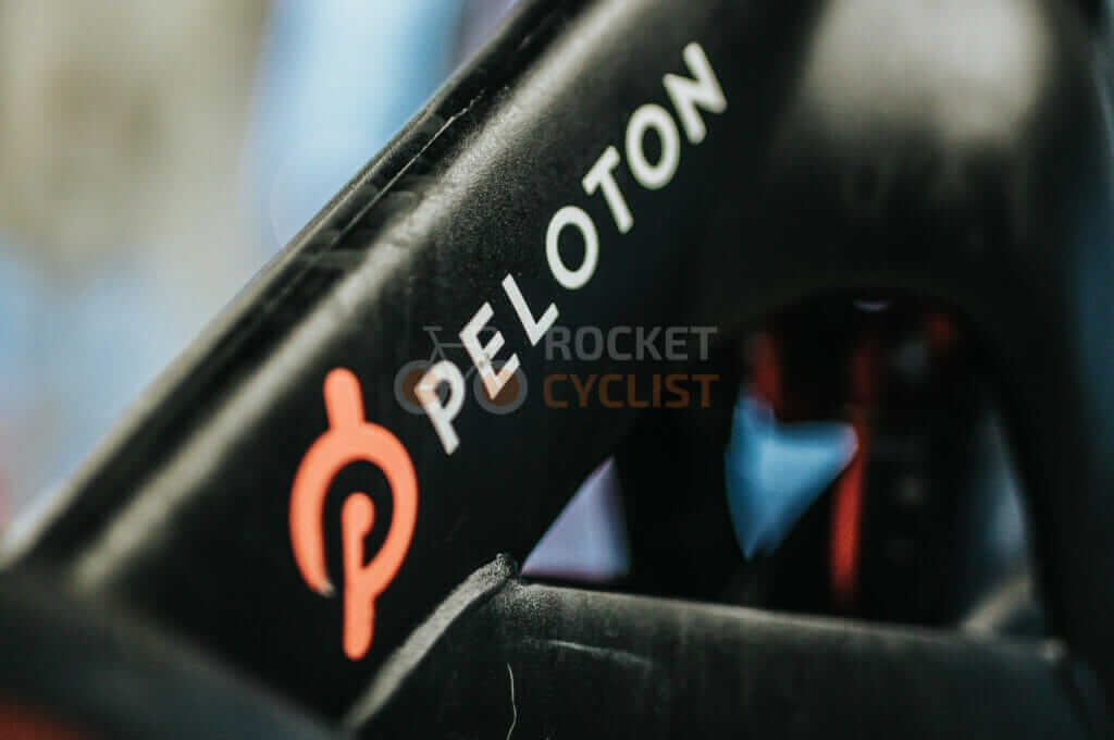 A close up of the peloton logo on a bike.