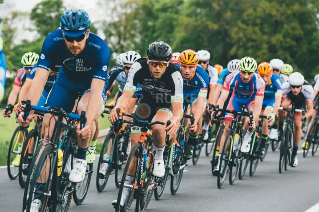 A group of cyclists racing down a road.