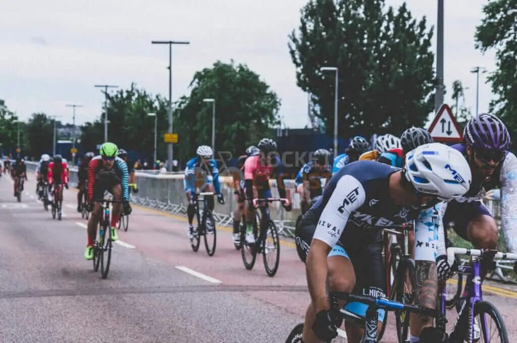 A group of cyclists racing down a street.
