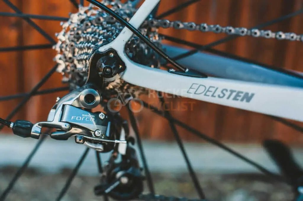A close up of a bicycle with a chain and brakes.
