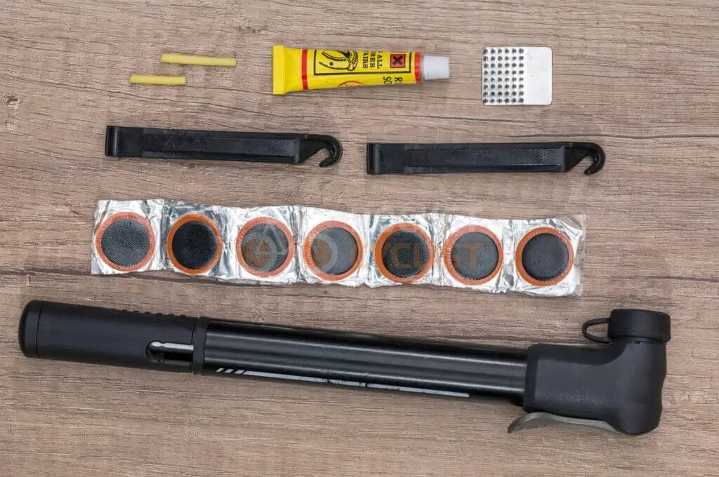 A gun and other items on a wooden table.