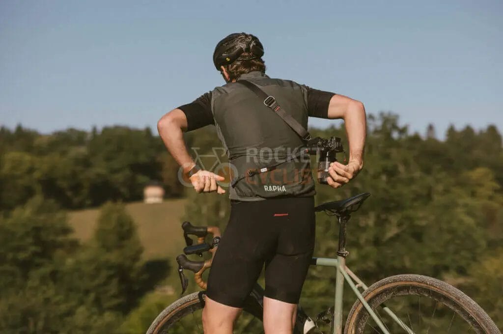 A man standing on a bike with his hands on the handlebars.