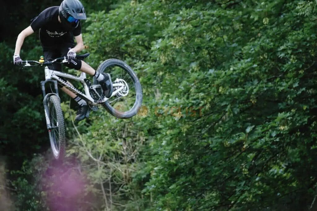 A man riding a mountain bike in the air.