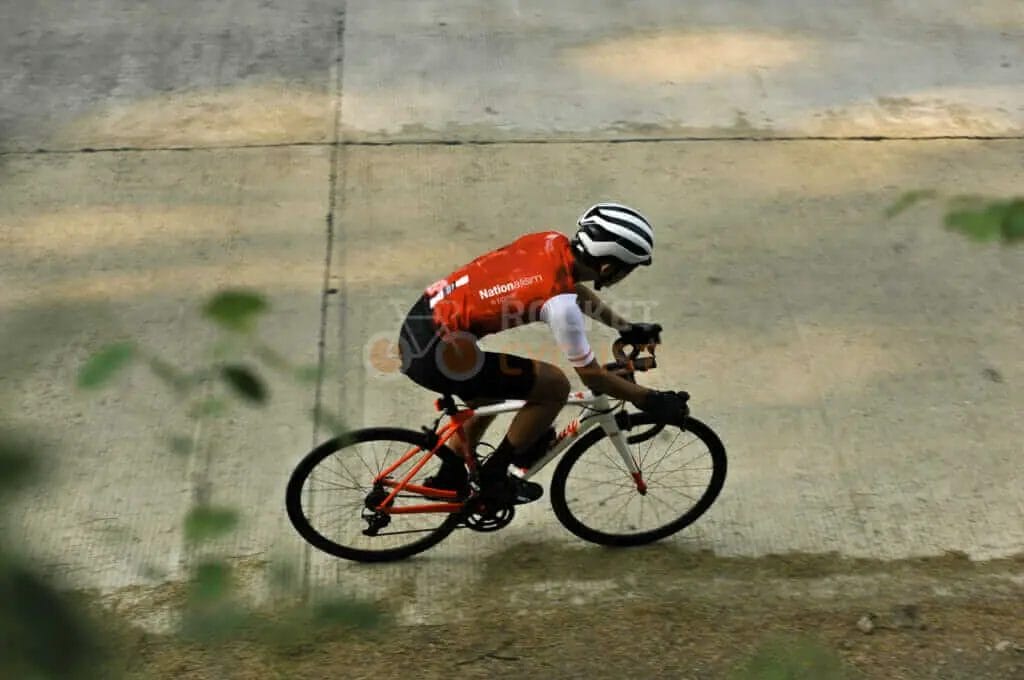A man riding a bicycle on a concrete surface.
