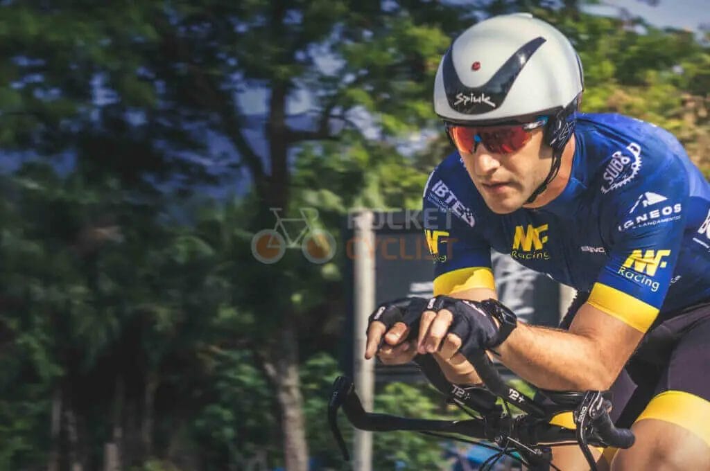 A man riding a bike with a helmet on.