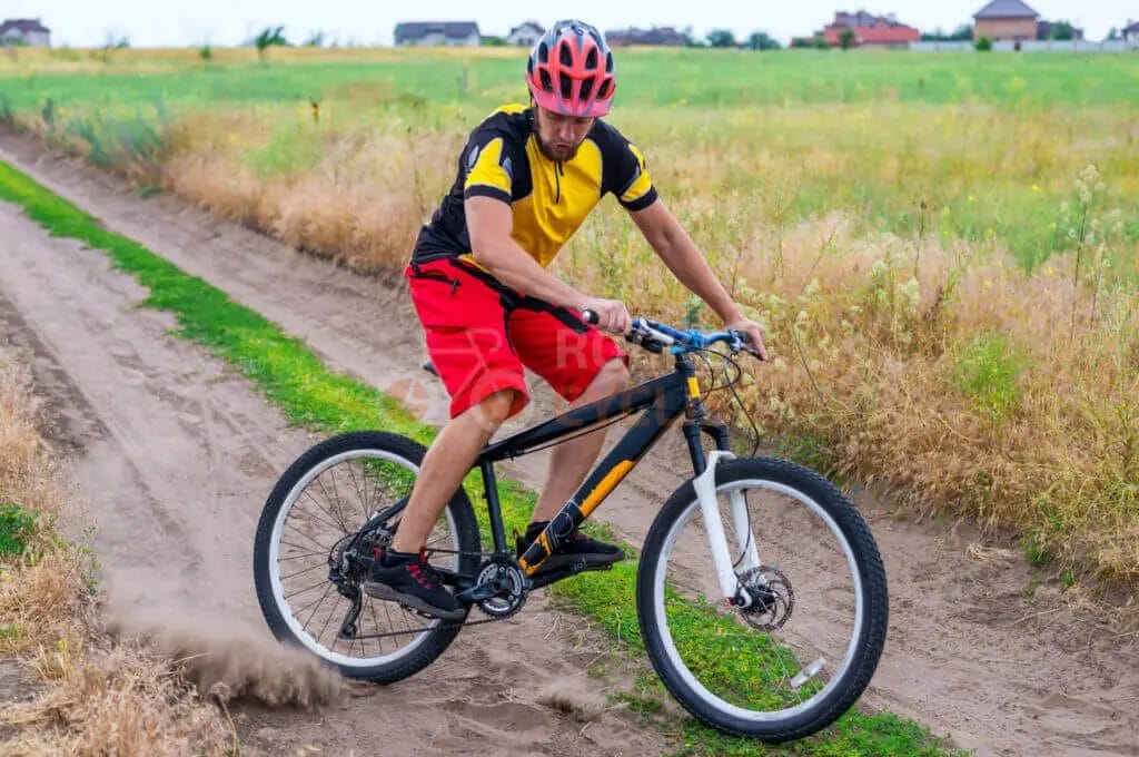 A man riding a mountain bike in a field.