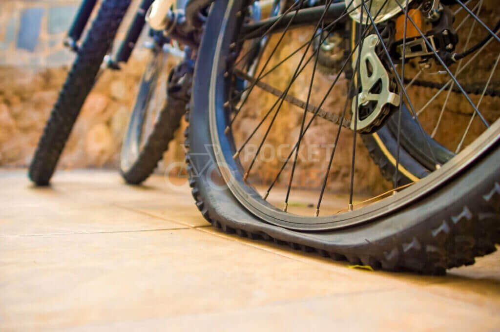 A bicycle tire on a tiled floor.