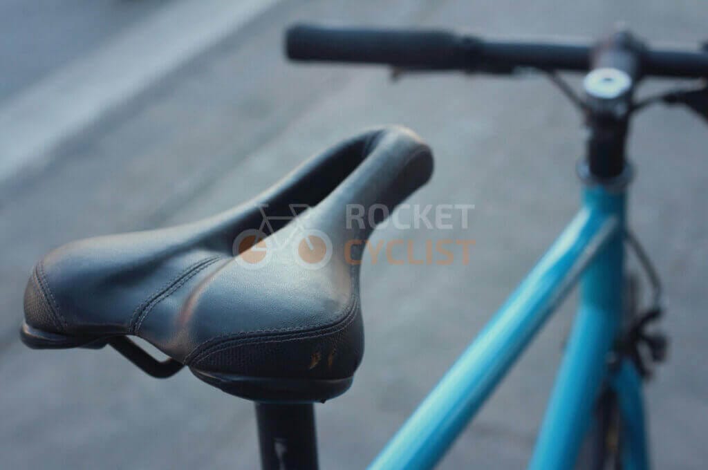 A close up of a blue bicycle seat.