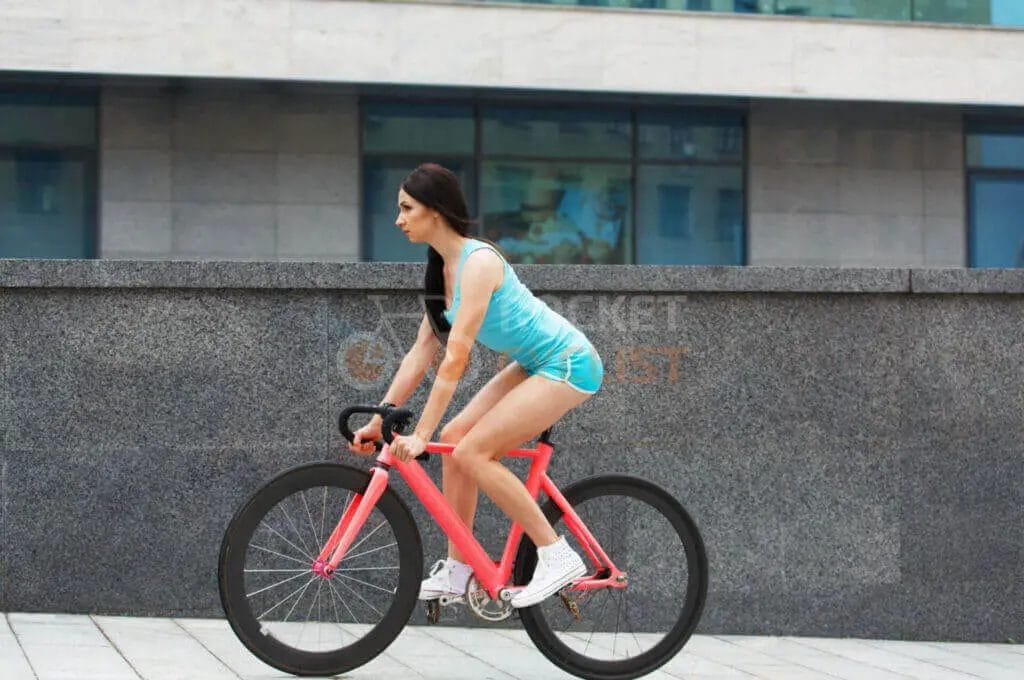 A woman is riding a bike.