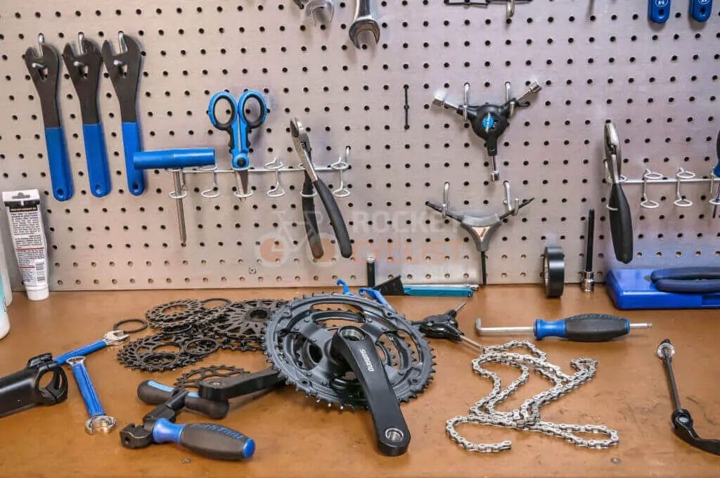 Various bicycle tools on a peg board.