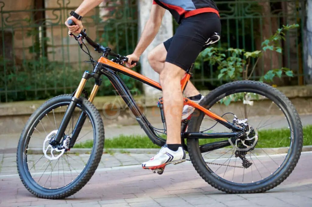 A man riding a mountain bike on a street.