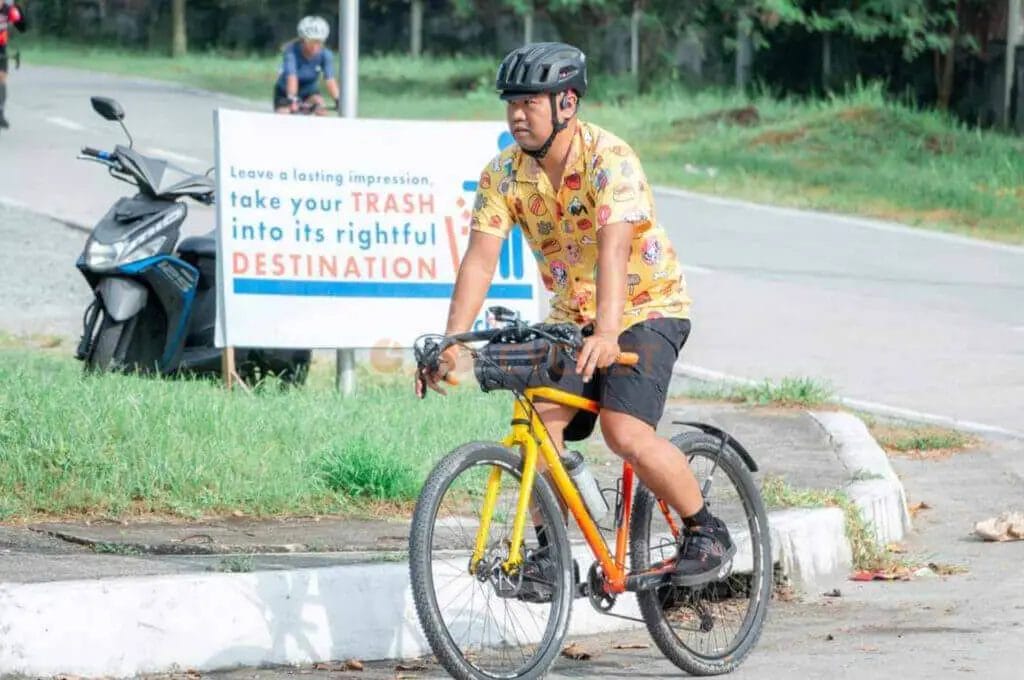 A man riding a bicycle on a road.