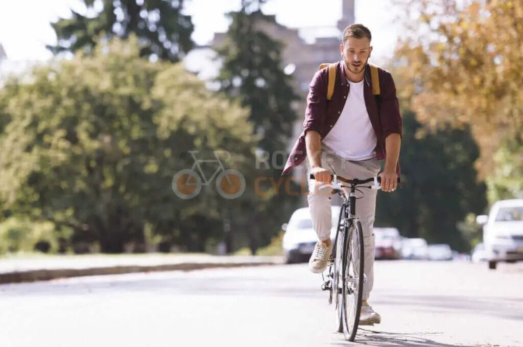 A man riding a bicycle on a street.