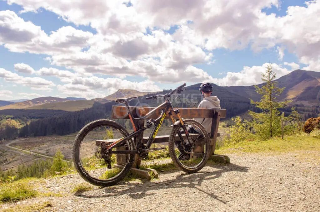 A mountain bike is parked on a bench.