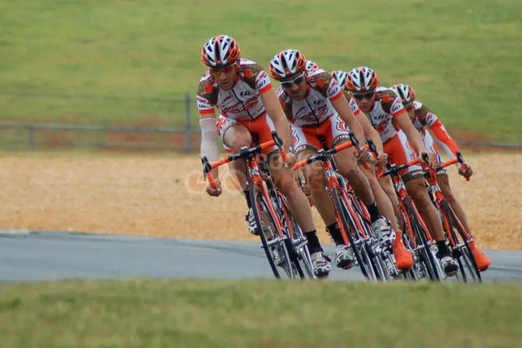 A group of cyclists on a race track.
