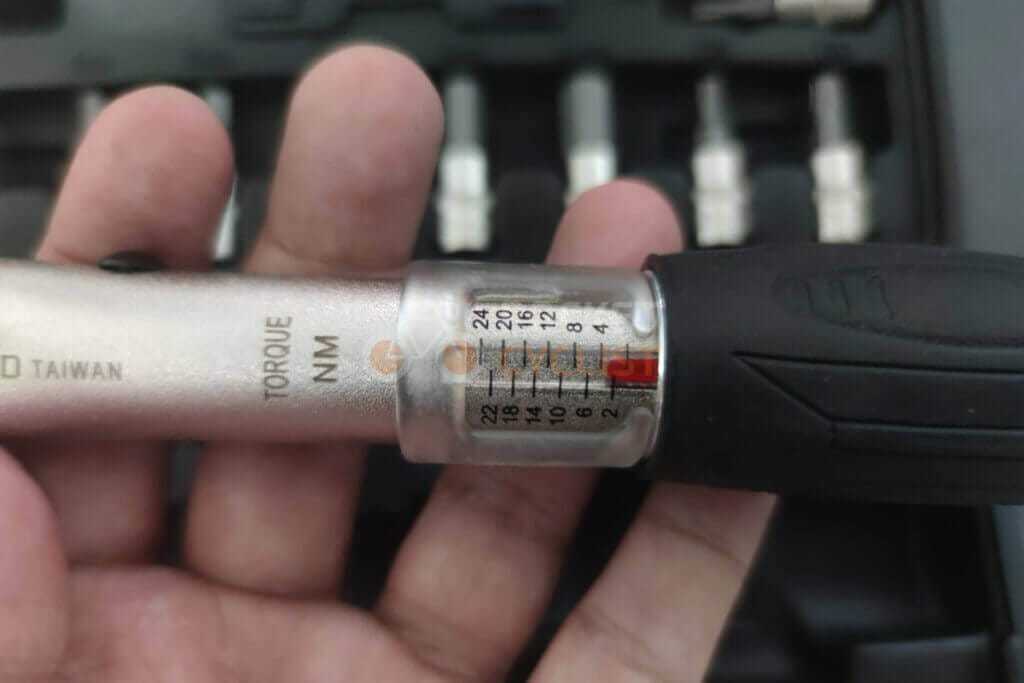 A person holding a screwdriver in their hand.