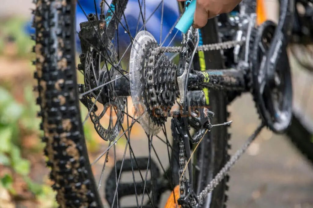 A person is working on a mountain bike.