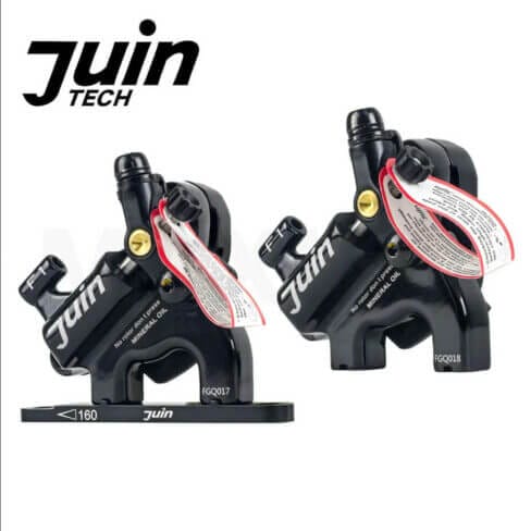 A pair of bicycle pedals with the words juin tech on them.