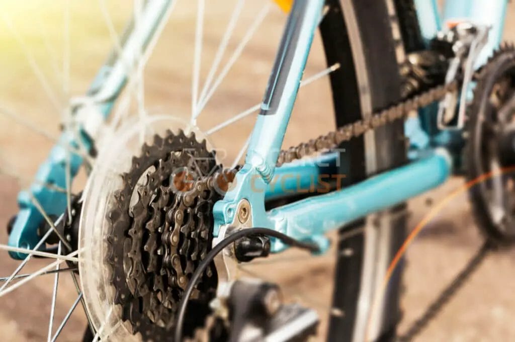 A close up of a blue bicycle with gears.