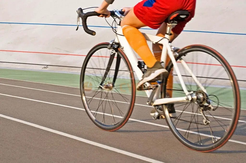 A person riding a bike on a track.