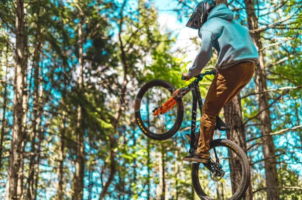 A person riding a mountain bike in the woods.