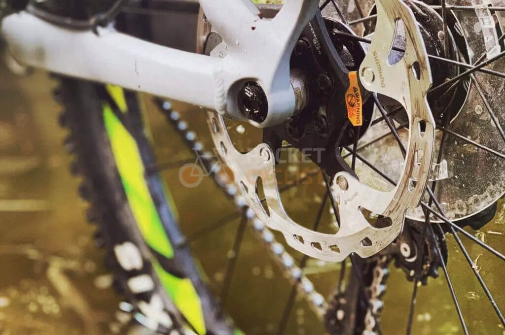 A close up of a bicycle wheel with a disc brake.