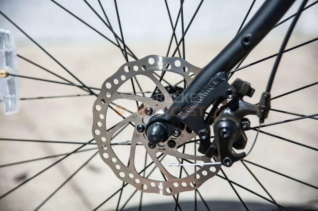 A close up of a bicycle wheel with a disc brake.