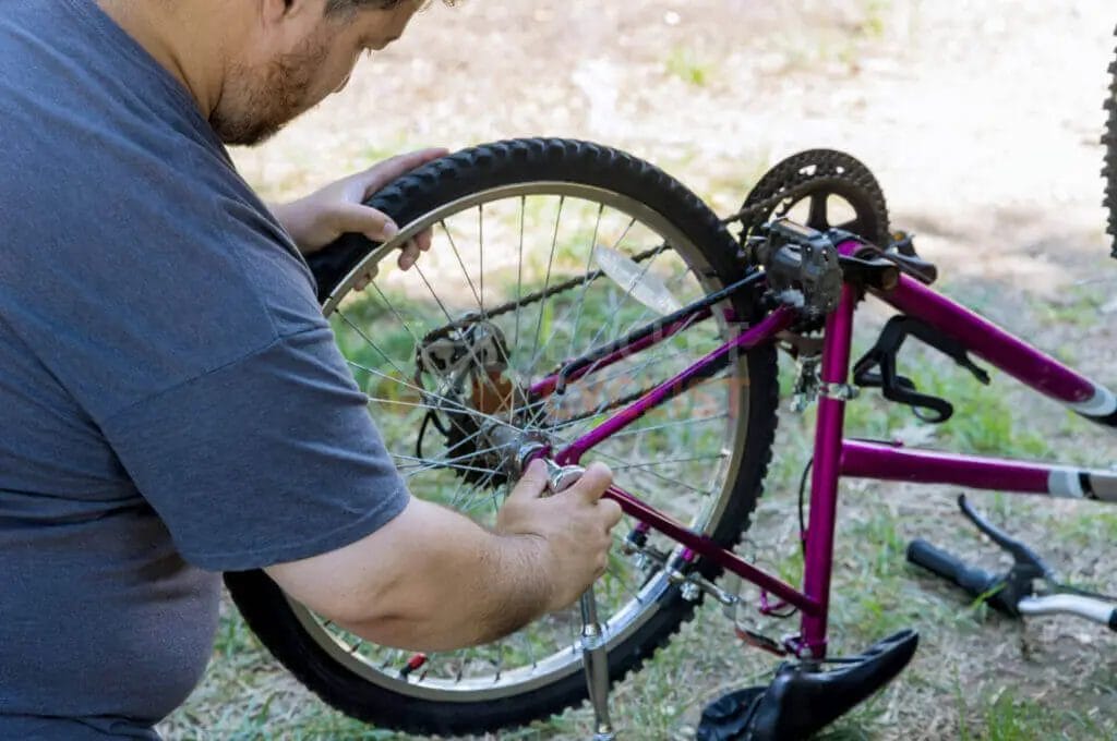 A man working on a bicycle.